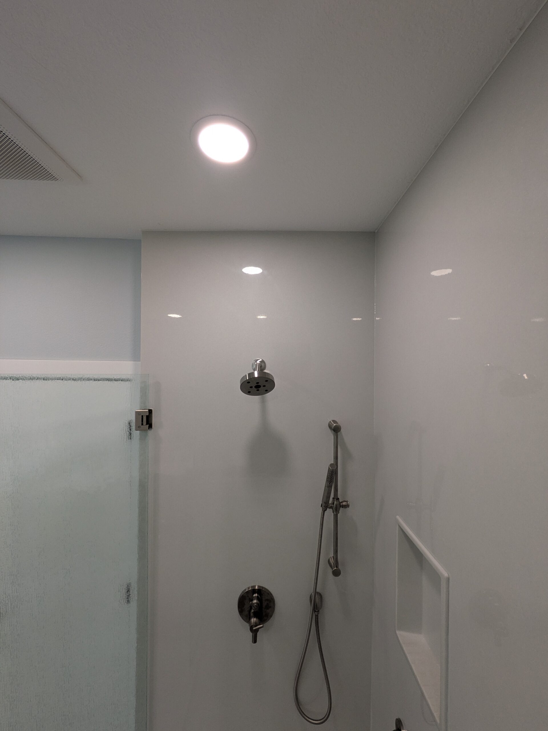 New shower fixtures and tiled niche after the remodel